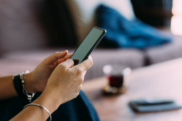 istock Anonymous Woman Texting On Her Mobile Phone 1400400370