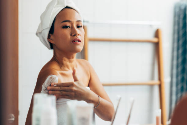 istock Asian Woman Applying Cream In The Mirror 1400400384