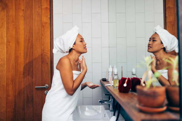 istock Asian Woman Applying Cream In The Mirror 1400400400