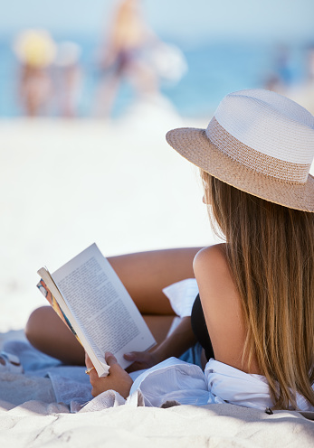 Side portrait of Modern girl in light summer dress with stylish hat enjoying sunset