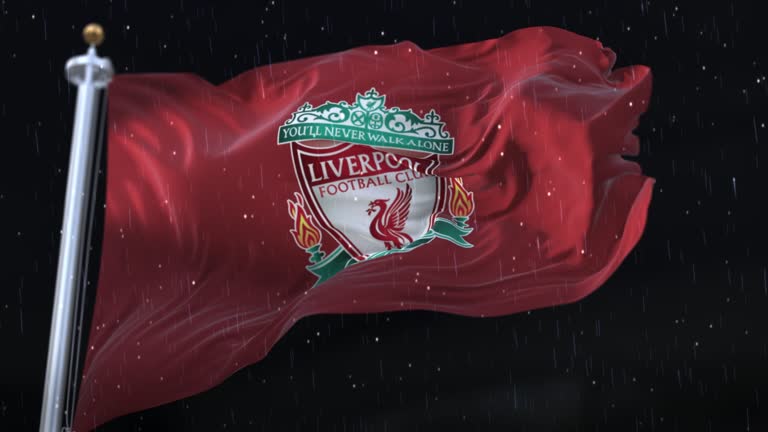 Flag of Liverpool Football Club Waving with rain and snow in the night. Loop