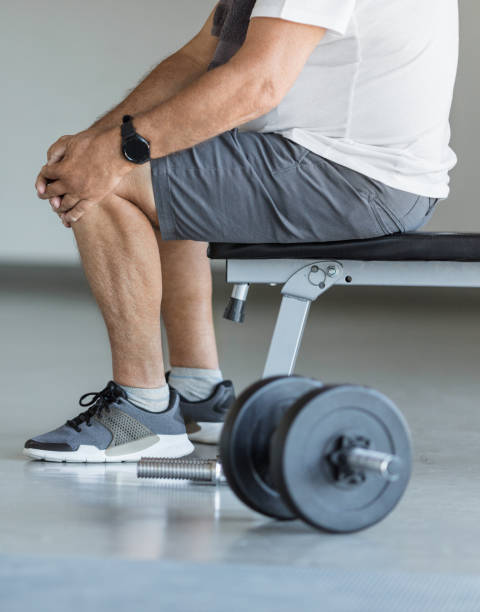 istock Active senior in gym with knee injury 1400403588