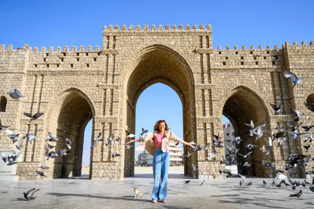 Photo of Portrait of smiling young tourist at Baab Makkah Jeddah