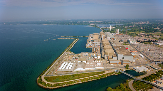 Pickering, Ontario, CA / USA - August 07, 2019: Aerial view of Pickering Nuclear Generating Station on shore of Lake Ontario in Southern Ontario, Canada.\n\nPickering Nuclear Generating Station is a Canadian nuclear power station located on the north shore of Lake Ontario in Pickering, Ontario. It is one of the largest nuclear stations in the world.