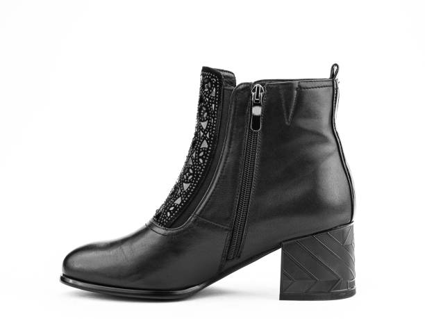istock Women's autumn ankle black leather boots with black zip and average heels, isolated white background. Left side view. Fashion shoes 1400405091