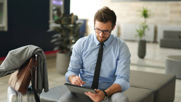 istock Businessman using digital tablet at train station 1400405127