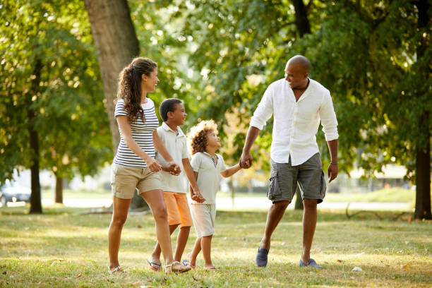 istock Happy couple spending time with their sons in the park 1400405454
