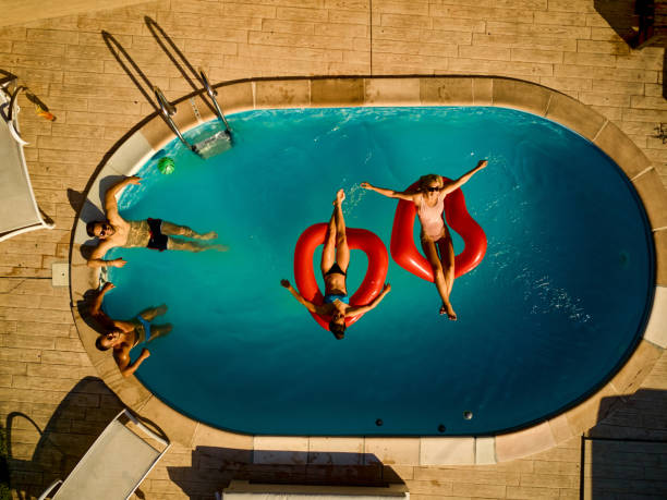 istock Playful friends hanging out at pool party 1400405495