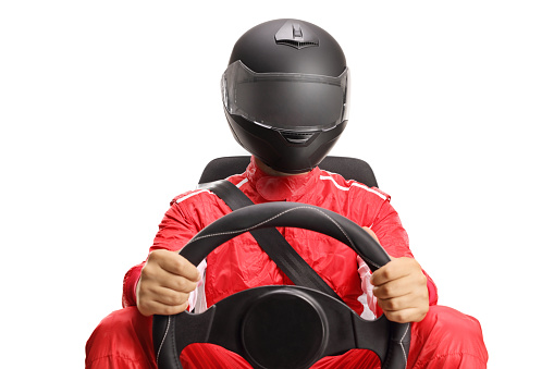 Car racer with a helmet holding a steering wheel isolated on white background