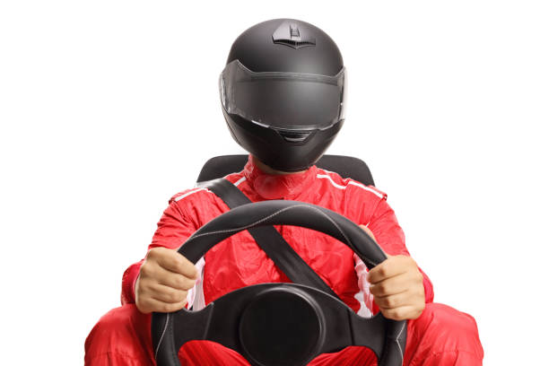 Car racer with a helmet holding a steering wheel Car racer with a helmet holding a steering wheel isolated on white background race car driver stock pictures, royalty-free photos & images