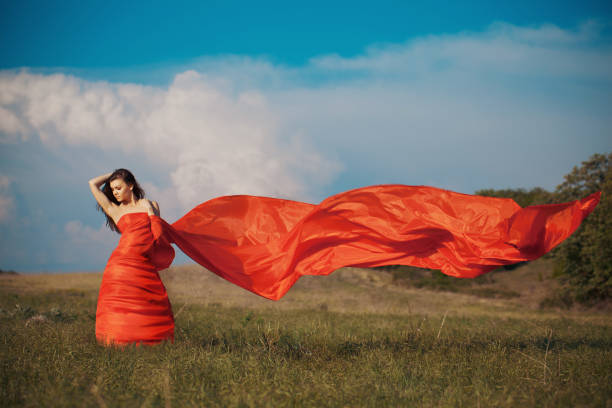 istock Relaxing beautiful woman walking alone on green grass in summer 1400407909