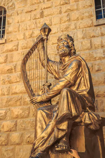 Golden statue of King David with harp in Jerusalem