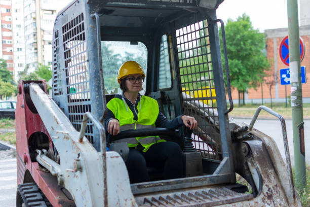 istock female construction worker driving earth mover 1400409905