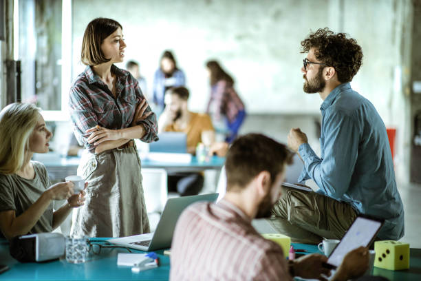 istock Young start up team talking at casual office. 1400411068