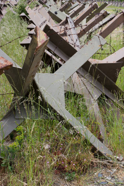 istock Hedgehod anti-tank barrier with barbed wire 1400415180