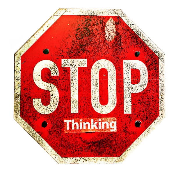 Stop Thinking, says road sign thanks to a word someone has stuck on to it stock photo