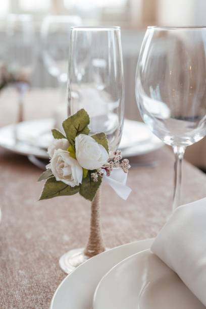 istock an empty champagne glass decorated with an artificial white fabric rose 1400416196