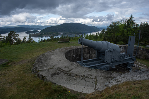 Frogn, Norway - May 21, 2022: Veisving battery was built in 1894-95 facing the fjord outside Storskiar. The battery has four Armstrong muzzle-loading guns. Sunny spring day. Selective focus