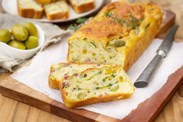 French savoury cake with olives, zucchini, ham and cheese French savoury cake with olives, zucchini, ham, sweet pepper and cheese pepper cake stock pictures, royalty-free photos & images