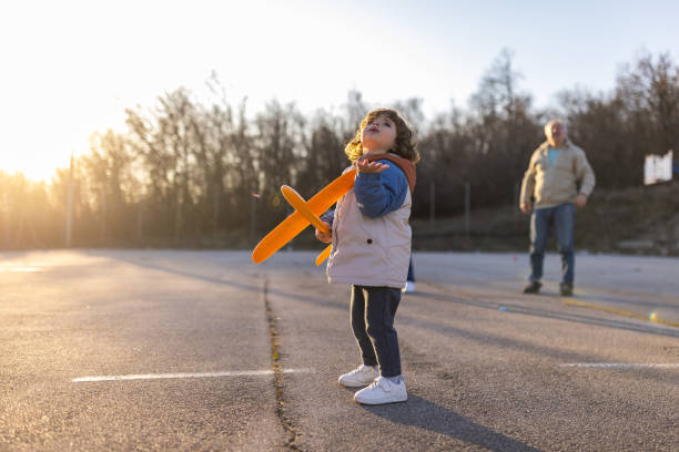 istock Toddler boy playing with airplane toy 1400419144