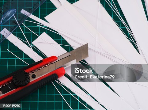 istock Pieces of paper, a knife and a ruler on top of a cutting mat 1400419210