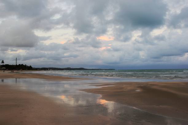 istock Cloudy and threatening sky over the beach, Dusk with wet sand and small waves. 1400419385