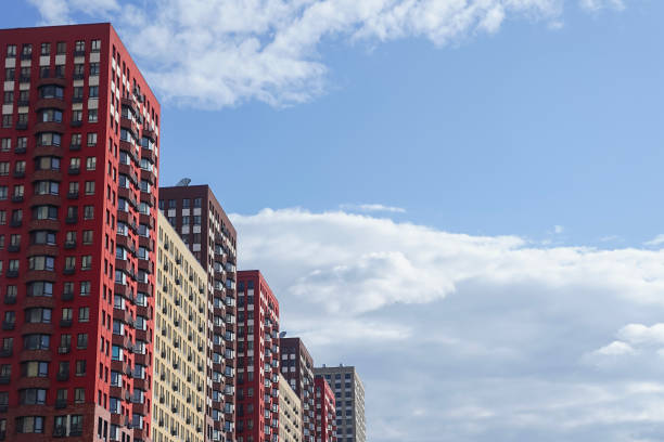 block of modern colorful residential buildings against blue sky - real estate imagens e fotografias de stock