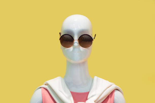 Mannequin wearing sunglasses against yellow background Mannequin wearing sunglasses against yellow background mannequin photos stock pictures, royalty-free photos & images