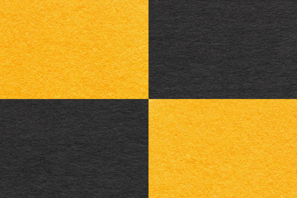 istock Texture of craft black and yellow paper background with cells pattern, macro. Structure of vintage kraft cardboard. 1400423980