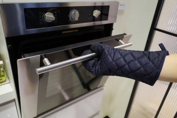 Young Man Opening the Oven
