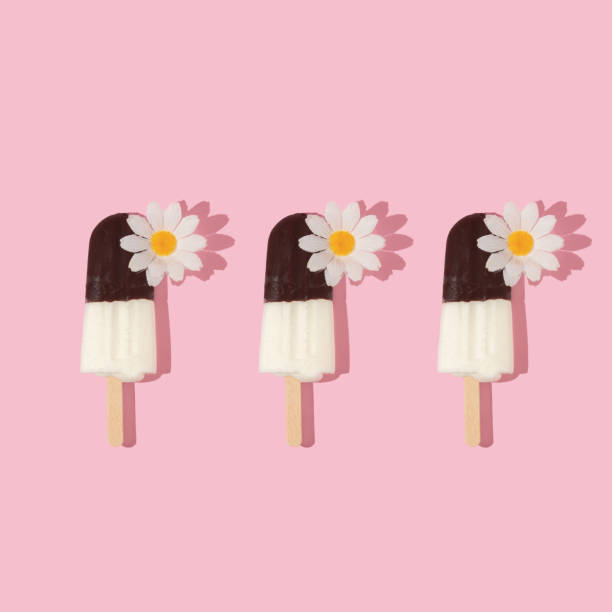 istock Summer creative patten with ice cream popsicles and white flowers on pastel pink background.  70s, 80s or 90s retro aesthetic fashion idea. Minimal summer idea. 1400427649