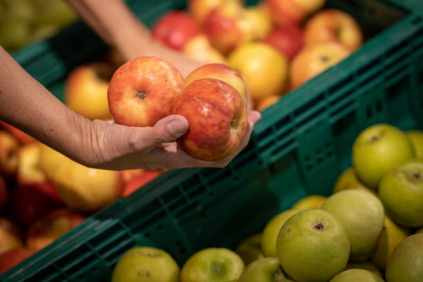 istock Close up woman holding apples 1400427980