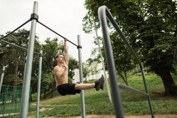istock Strong shirtless caucasian athlete performing corner on horizontal bar 1400428055