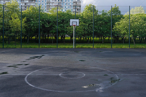 Basketball court with hoop in a public park, plyground in the city