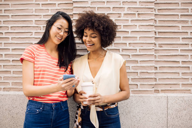 istock Best friends enjoying in Madrid, using smartphone and having fun 1400430217