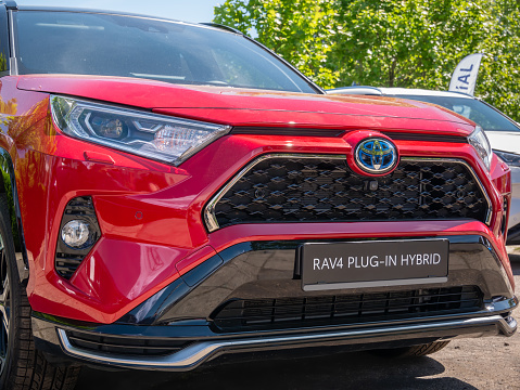 Bucharest, Romania - 05.20.2022: Close up detail with the front hood bar of the new Toyota RAV4 Plug-in-Hybrid car