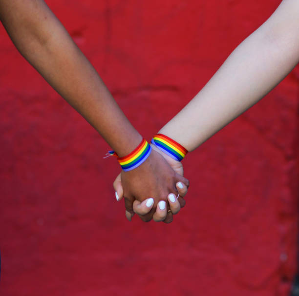 istock GIRLS WHO HOLD HANDS WITH RAINBOW BRACELETS 1400432530