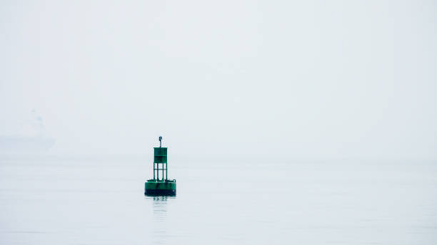 istock Navigation buoy in river fog 1400433651