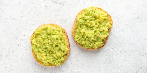 istock Vegan Toast with mashed avocado on grey 1400433815