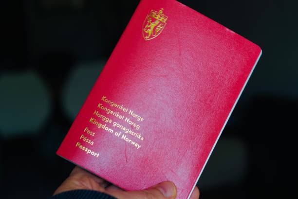 istock A hand holding up a Norwegian passport 1400434322