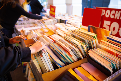 Vintage old hardback books, diary, fanned pages on wooden desk table and grunge background Daylight. Books stacking. Back to school. Copy Space. Education background