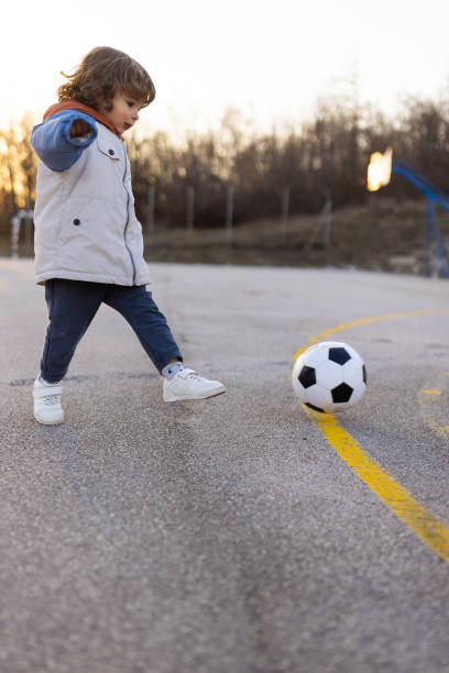 istock Toddler boy playing soccer 1400437790