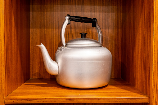 A traditional silver kettle made of aluminum commonly found in Indonesia households.