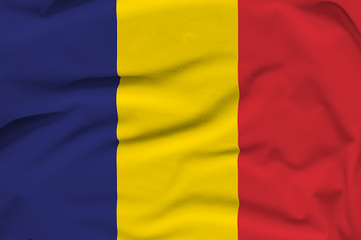 Chad national flag, folds and hard shadows on the canvas.