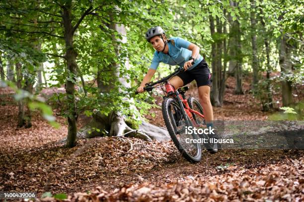 Young Woman With Mountain Bike On Italian Mountains Downhill In The Forest Stock Photo - Download Image Now