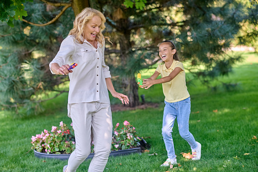 Leisure. Mom and daughter playing in the park and looking happy