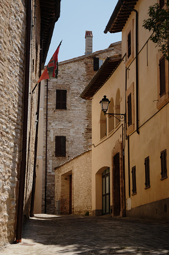 The Main Street in Nocera Umbra with a flag of the village