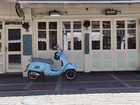 ioannina , greece, 1 june 2022, motorbike outside a scenic local building in kalari street in historical center