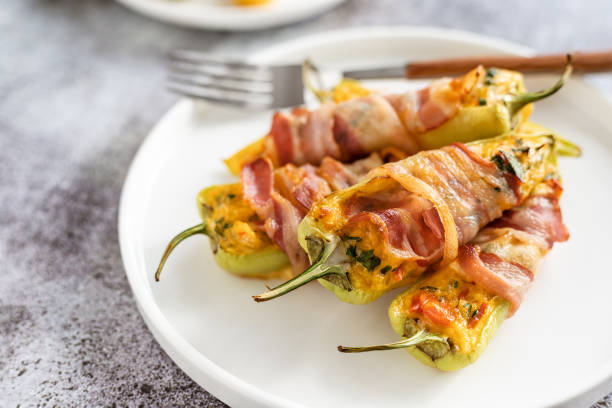 Stuffed pepper baked in bacon and served