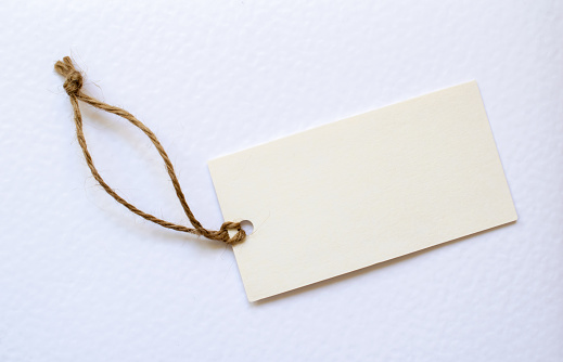 white card with string on white background. place for text.